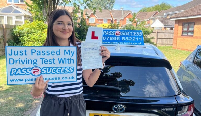 "Aderlina holding her pass certificate after passing her automatic driving test first time at South Yardley Driving Test Centre with Pass2Success Driving School Birmingham"