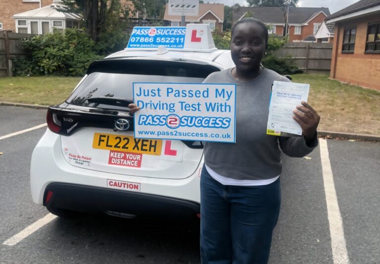 Chinelo Osegbe celebrating first-time automatic driving test pass in South Yardley