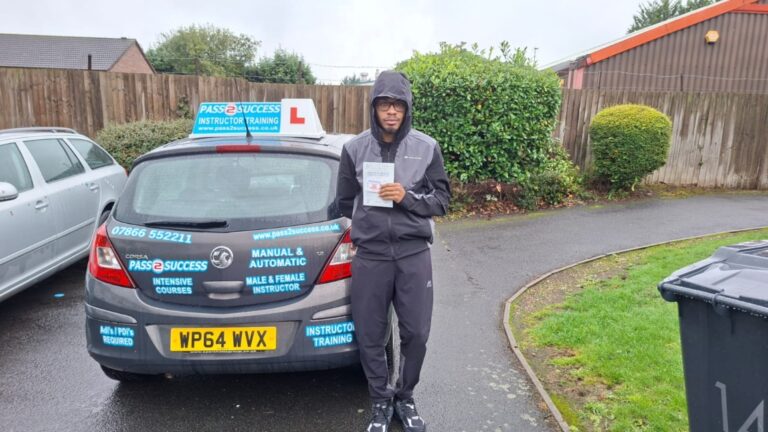 Happy learner driver Reece holding pass certificate at Kingstanding Test Centre Birmingham